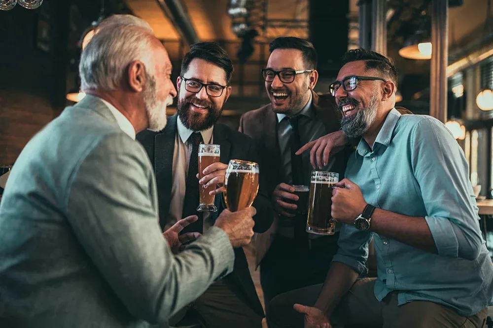 group of men drinking, discussing how long alcohol stays in system