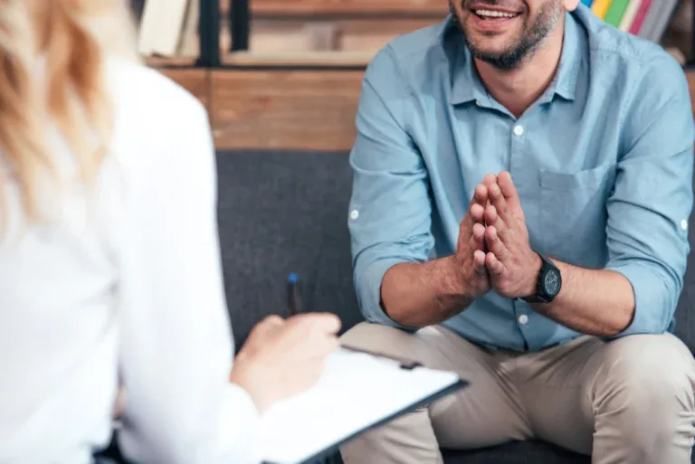 Therapist listening to her patient's experiences in a painkiller treatment center