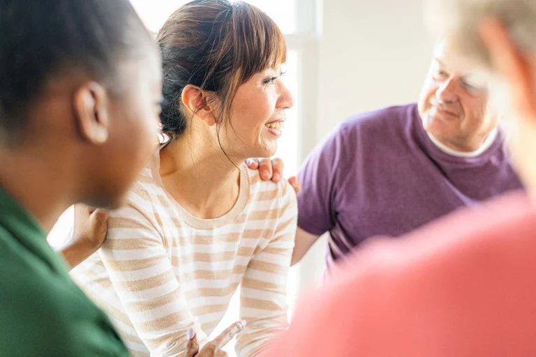 A supportive therapist helping her patient learn how to recover from alcoholism.