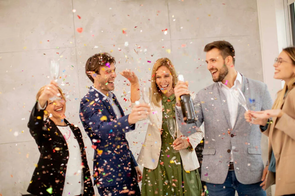 Friends celebrating positive change and goal setting, representing mental health New Year’s resolutions focused on growth and well-being.