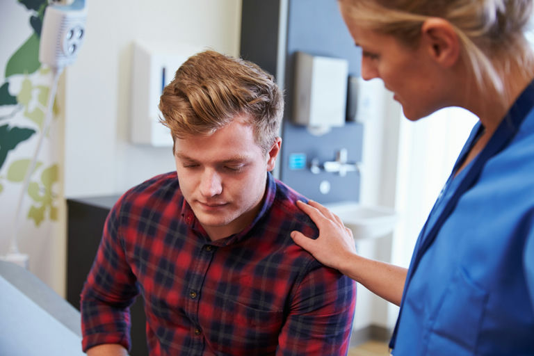A therapist explaining medication-assisted treatment to a family for support