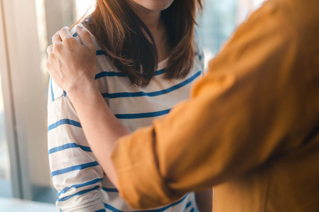 a person consoles another after talking about Intensive outpatient program vs partial hospitalization