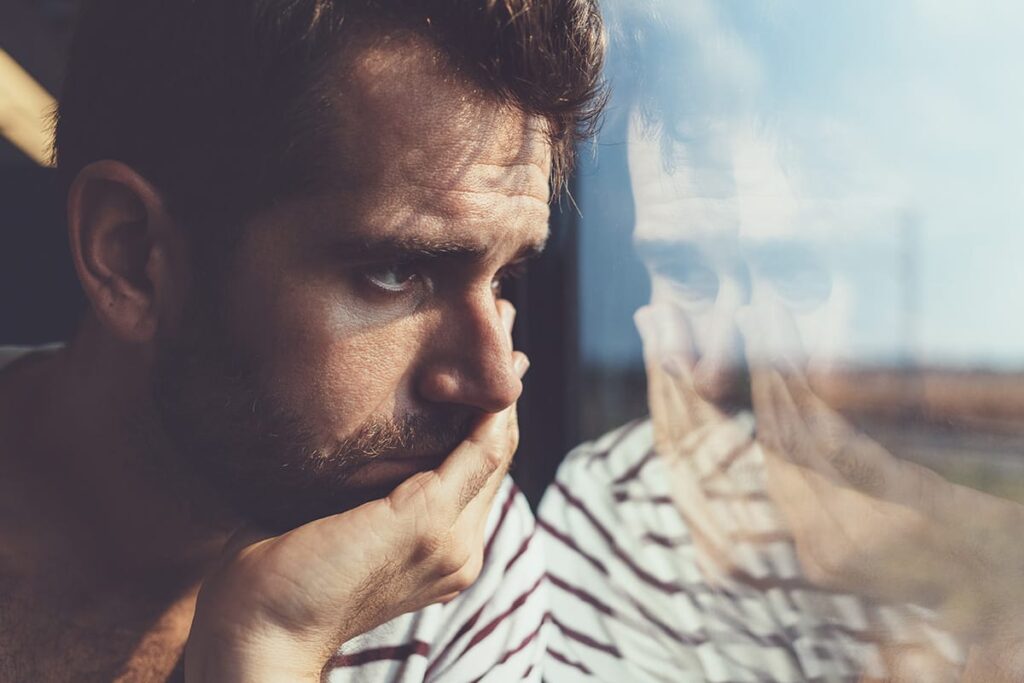 a person looks sad while looking out a window and wondering what is fentanyl