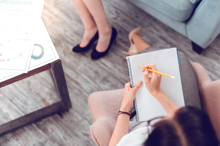 Therapist taking notes during an intensive outpatient program